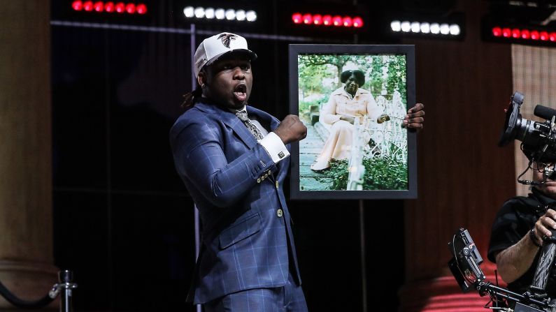 Takkarist McKinley holds up a photo of his late grandmother, Myrtle Collins, after he was selected by Atlanta in the NFL Draft on Thursday, April 27. "I told her, before she passed away, I was going to live my dream," McKinley said during a passionate interview with NFL Network.