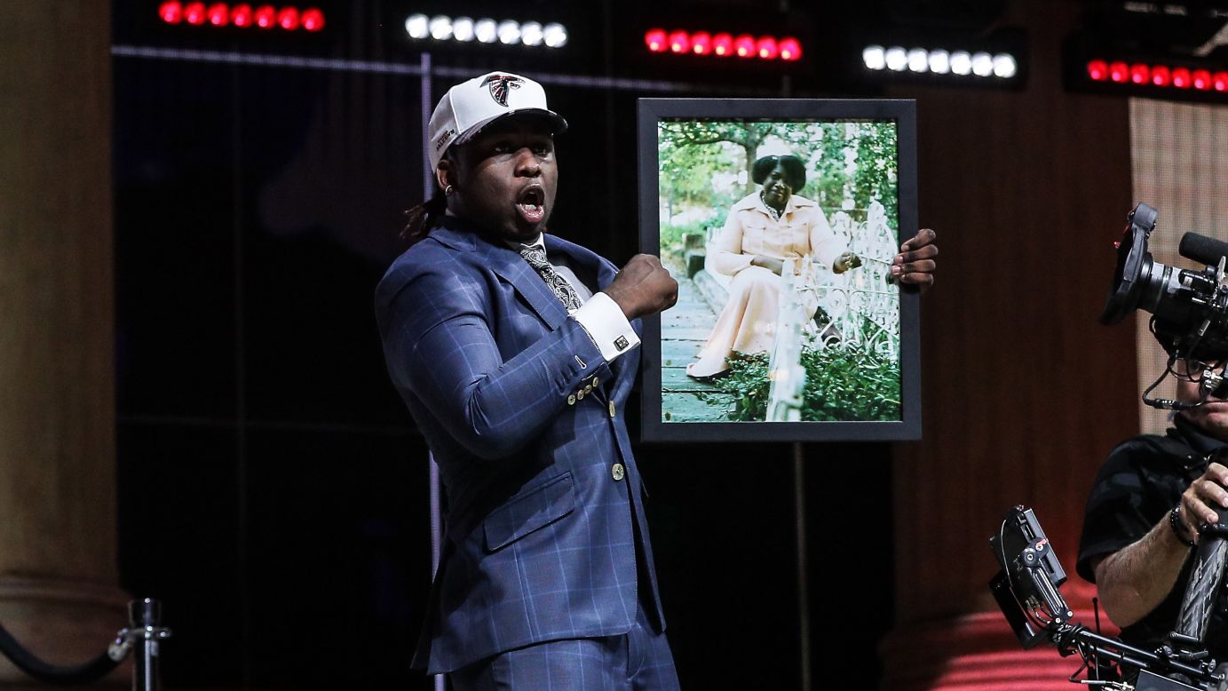 Takkarist McKinley holds up a photo of his late grandmother, Myrtle Collins, after he was selected by Atlanta in the NFL Draft on Thursday, April 27. "I told her, before she passed away, I was going to live my dream," McKinley said during a passionate interview with NFL Network.