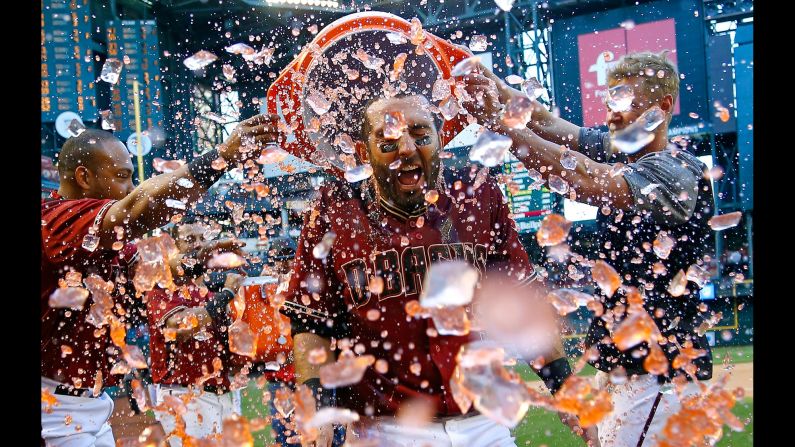 Daniel Descalso is doused by his Arizona teammates after his walk-off home run beat Colorado on Sunday, April 30.