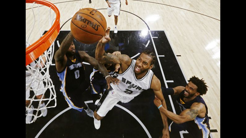 Kawhi Leonard is fouled as he drives to the hoop during an NBA playoff game in San Antonio on Tuesday, April 25. Leonard had 28 points as the Spurs defeated Memphis 116-103, and they closed out the series two days later. 