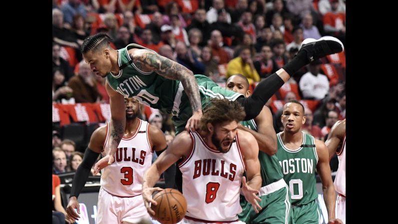 Boston's Gerald Green falls on Chicago's Robin Lopez during an NBA playoff game on Friday, April 28.
