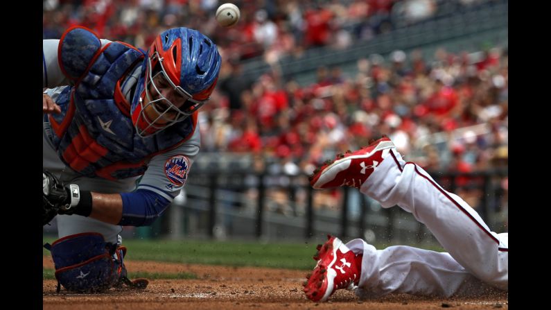 New York Mets catcher Rene Rivera can't come up with the ball to tag Washington's Anthony Rendon on Sunday, April 30. Rendon went 6-for-6 -- with three home runs and 10 RBIs -- as the Nationals crushed the Mets 23-5.