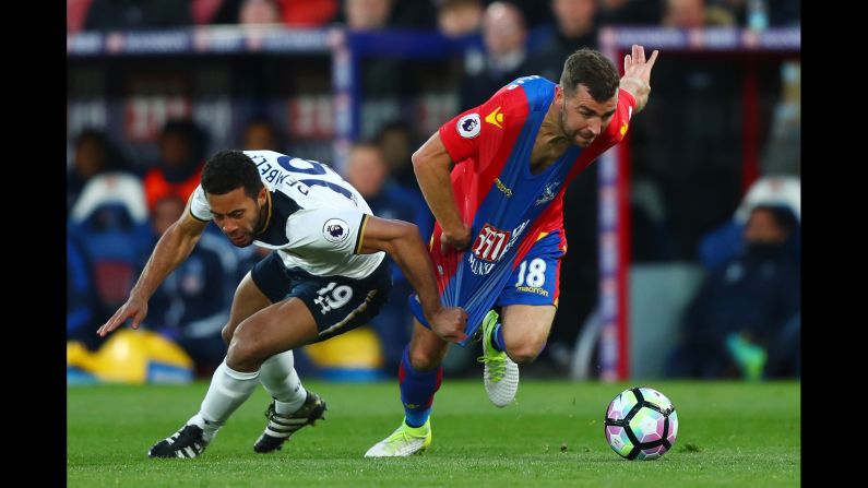 Tottenham midfielder Mousa Dembele pulls the shirt of Crystal Palace's James McArthur during a Premier League match in London on Wednesday, April 26.