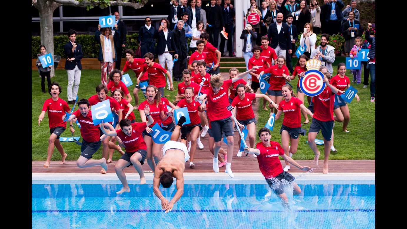 Tennis star Rafael Nadal dives into a swimming pool with ball boys and girls after winning the Barcelona Open in Spain on Sunday, April 30. It was the 10th time he won the tournament.