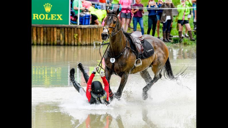 Rachel McDonough falls off her horse Irish Rhythm during an equestrian event in Lexington, Kentucky, on Saturday, April 29.