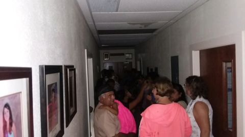 Parishioners shelter inside a hallway at St. John the Evangelist Catholic Church in Emory.