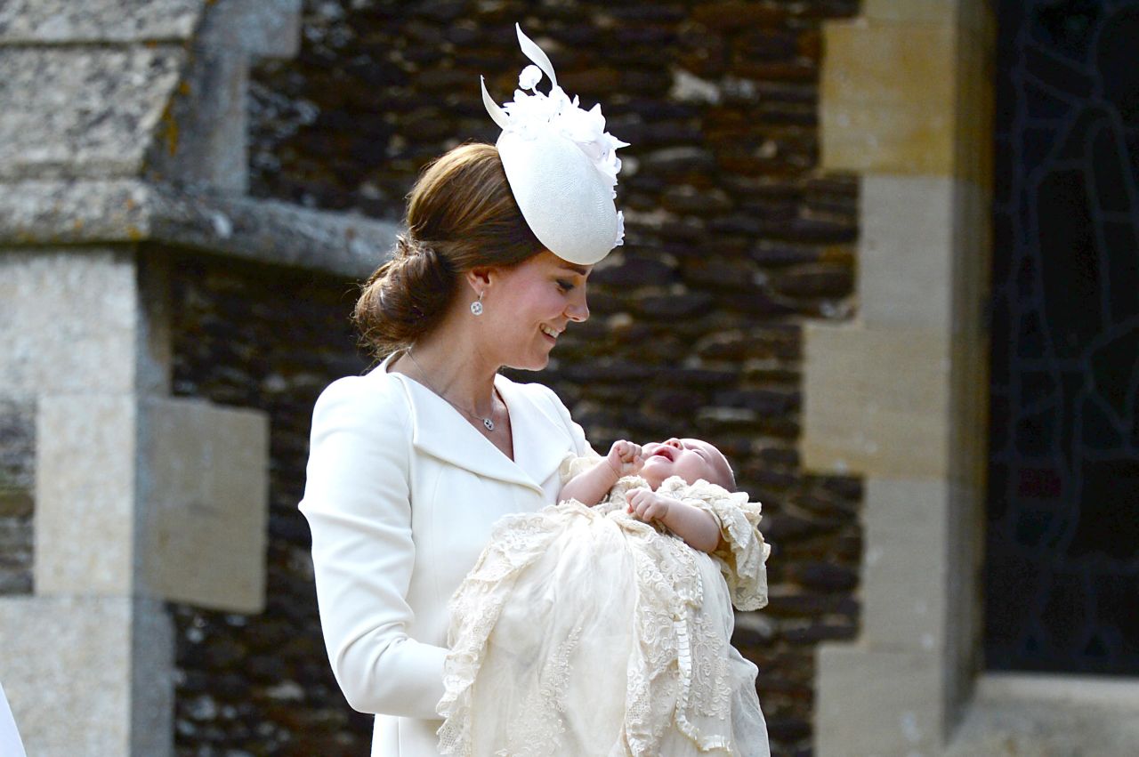 Charlotte is carried by her mother as they arrive for her christening.