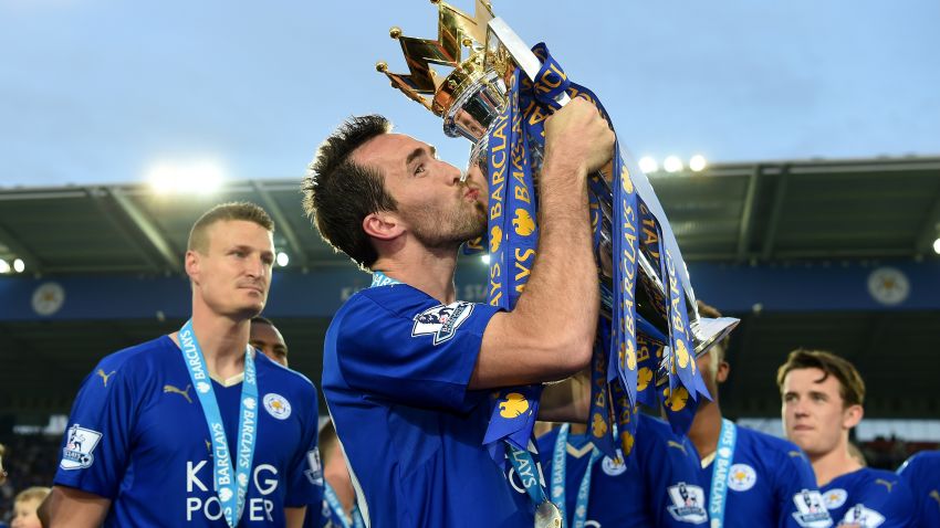 LEICESTER, ENGLAND - MAY 07:  Christian Fuchs of Leicester City kisses the Premier League Trophy as players and staffs celebrate the season champions after the Barclays Premier League match between Leicester City and Everton at The King Power Stadium on May 7, 2016 in Leicester, United Kingdom.  (Photo by Michael Regan/Getty Images)