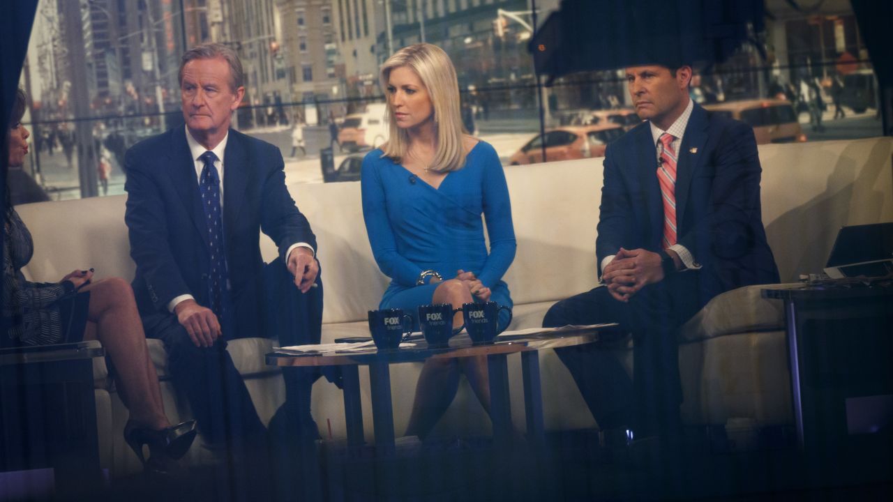 NEW YORK, NY - FEBRUARY 17: Seen through a window, (L to R) hosts Steve Doocy, Ainsley Earhardt, and Brian Kilmeade broadcast 'Fox And Friends' from the Fox News studios, February 17, 2017 in New York City. President Trump, a frequent consumer and critic of cable news, recently tweeted that Fox and Friends is 'great'. (Photo by Drew Angerer/Getty Images)