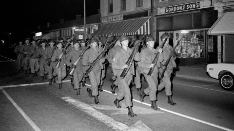 National Guardsmen with rifles and fixed bayonets march double-time on February 8, 1968, outside the main entrance to South Carolina State.