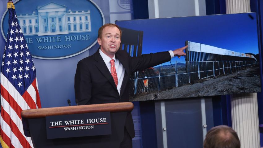 Office of Management and Budget Director Mick Mulvaney points to an image for a border fence during a briefing in the Brady Briefing Room of the White House on May 2, 2017 in Washington, DC. / AFP PHOTO / MANDEL NGAN        (Photo credit should read MANDEL NGAN/AFP/Getty Images)