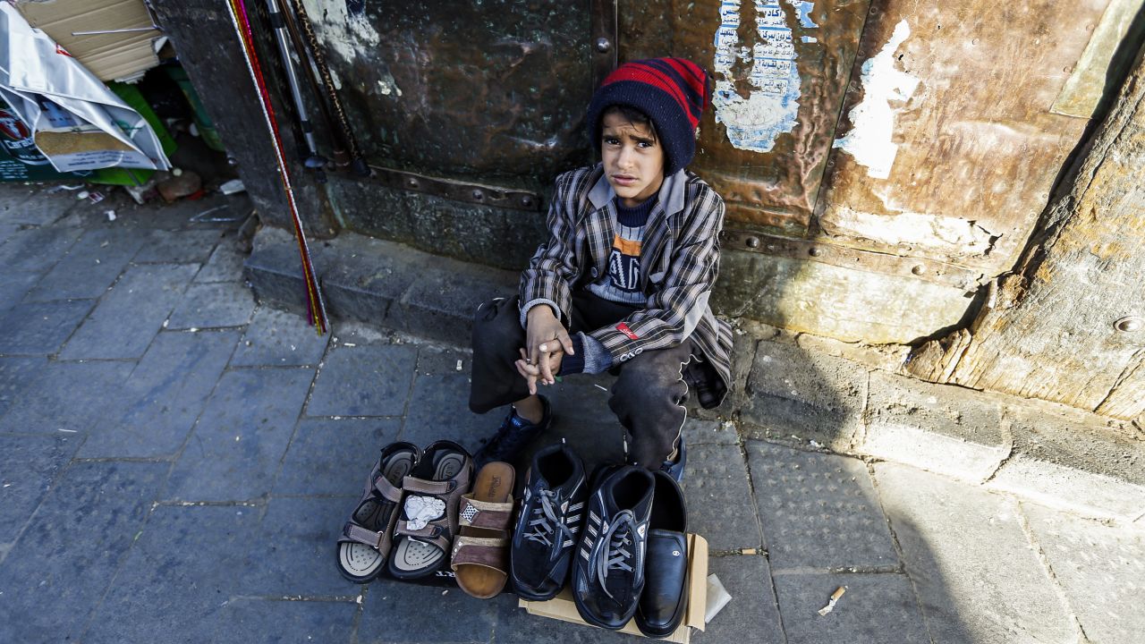 A Yemeni child peddlar sells shoes in Sanaa's Suq Al-Melh (Salt Market) on January 24, 2017.
Scores of Yemeni children orphaned by the war are now deployed at road junctions begging for the little that would feed them and their siblings. 
 / AFP / TO GO WITH AFP STORY BY JAMIL NASSER        (Photo credit should read /AFP/Getty Images)