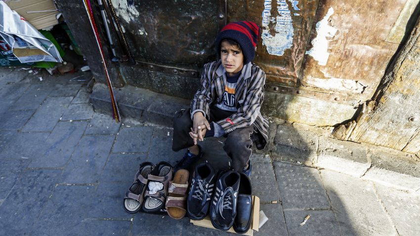 A Yemeni child peddlar sells shoes in Sanaa's Suq Al-Melh (Salt Market) on January 24, 2017.
Scores of Yemeni children orphaned by the war are now deployed at road junctions begging for the little that would feed them and their siblings. 
 / AFP / TO GO WITH AFP STORY BY JAMIL NASSER        (Photo credit should read /AFP/Getty Images)