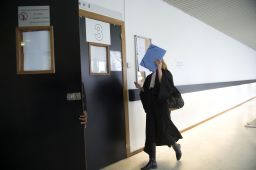 A lawyer enters the courtroom on opening day of a trial related to paparazzi photos of Princess Kate.