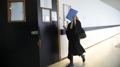 A lawyer enters the courtroom on opening day of a trial related to paparazzi photos of Princess Kate.