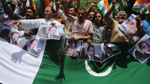 Hindu nationalists hold pictures of Pakistan Prime Minister Nawaz Shariz while shouting anti-Pakistan slogans during a rally in Jammu, India Tuesday. 