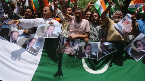 Hindu nationalists hold pictures of Pakistan Prime Minister Nawaz Shariz while shouting anti-Pakistan slogans during a rally in Jammu, India Tuesday.