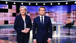 French presidential election candidate for the far-right Front National (FN) party, Marine Le Pen (L) and French presidential election candidate for the En Marche ! movement, Emmanuel Macron pose prior to the start of a live brodcast face-to-face televised debate in television studios of French public national television channel France 2, and French private channel TF1 in La Plaine-Saint-Denis, north of Paris, on May 3, 2017 as part of the second round election campaign.
Pro-EU centrist Emmanuel Macron and far-right leader Marine Le Pen face off in a final televised debate on May 3 that will showcase their starkly different visions of France's future ahead of this weekend's presidential election run-off. 