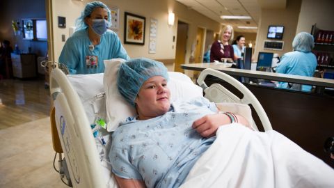 Nurse Kirby Ginn wheels Jessica toward the operating room.