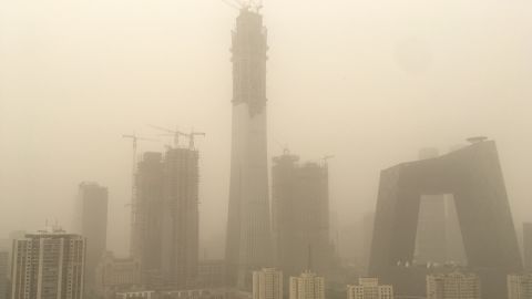 Central Beijing sits under a thick layer of smog Thursday, as a sandstorm swept north east China.