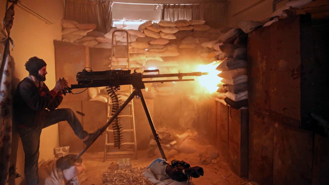 An opposition fighter fires a  machine gun in Jobar, a rebel-held district outside Damascus, in March.