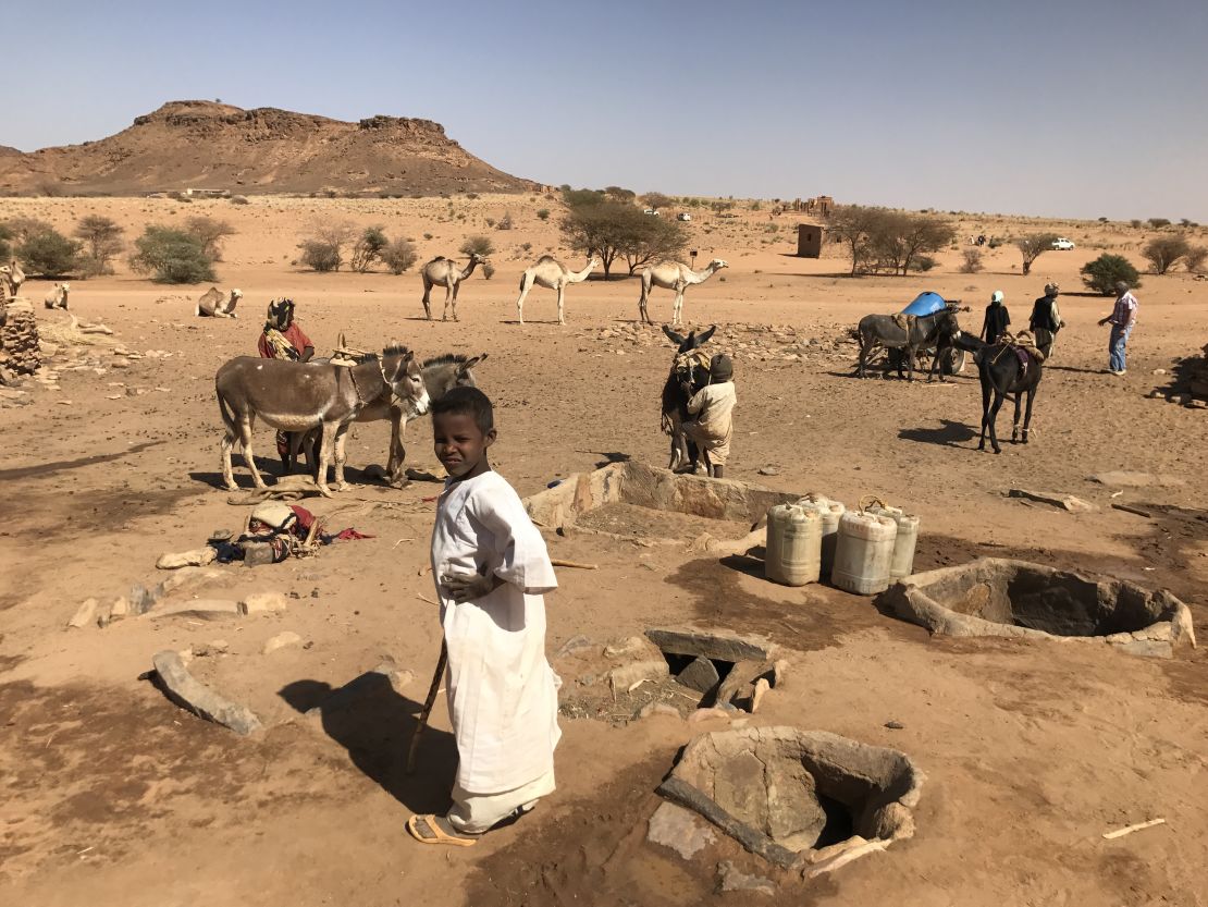 A Sudanese boy poses in the desert.