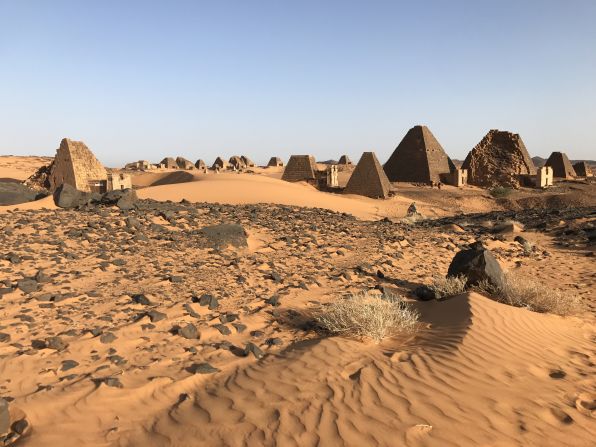 The landscape leading up the UNESCO World Heritage Site is dramatic, with sweeping sand dunes and clear skies.