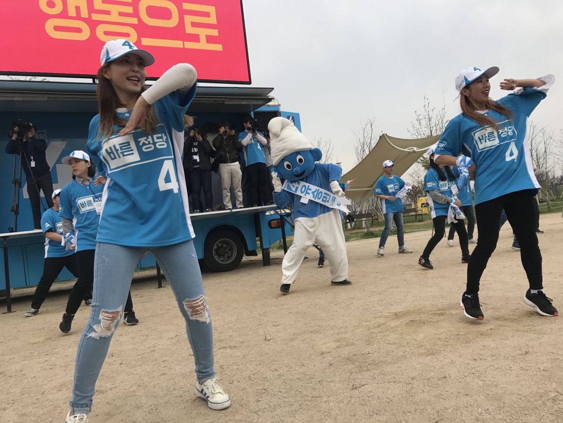 Supporters of South Korean presidential candidate Yoo Seong-min dance with a giant Smurf.