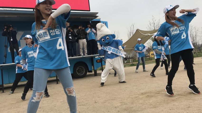 Supporters of South Korean presidential candidate Yoo Seong-min dance with a giant Smurf.