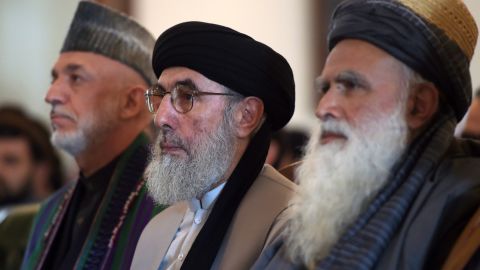 Hekmatyar (center) sits with former Afghan president Hamid Karzai (left) and Afghan former mujahideen leader Abdul Rasul Sayaf (right) during a ceremony at the presidential palace in Kabul.
