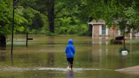 A child walks in his flooded neighborhood Thursday in Arnold, Missouri.