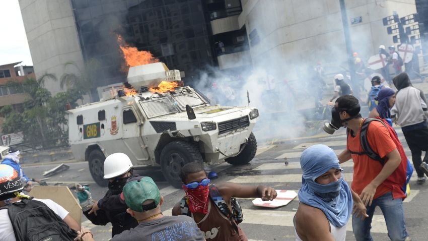 A charging National Guard riot control vehicle is hit by a Molotov cocktail thrown by a demonstrator during a protest against Venezuelan President Nicolas Maduro, in Caracas on May 3, 2017.
Venezuela's angry opposition rallied Wednesday vowing huge street protests against President Nicolas Maduro's plan to rewrite the constitution and accusing him of dodging elections to cling to power despite deadly unrest. / AFP PHOTO / FEDERICO PARRA        (Photo credit should read FEDERICO PARRA/AFP/Getty Images)
