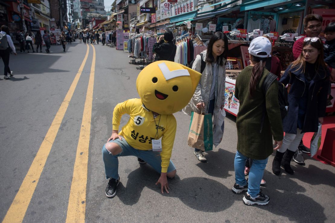 A supporter of South Korean presidential candidate Sim Sang-Jung poses on a street prior to a campaign rally event in Hongdae, Seoul.