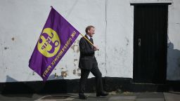HARTLEPOOL, ENGLAND - APRIL 29: A UK Independence party supporter carries a party flag as leader Paul Nuttall visits Hartlepool on April 29, 2017 in Hartlepool, United Kingdom. Mr Nuttall announced he would stand in the Boston and Skegness constituency when Britain goes to the polls on June 8, 2017 after British Prime Minister Theresa May called for a snap general election.  (Photo by Ian Forsyth/Getty Images)
