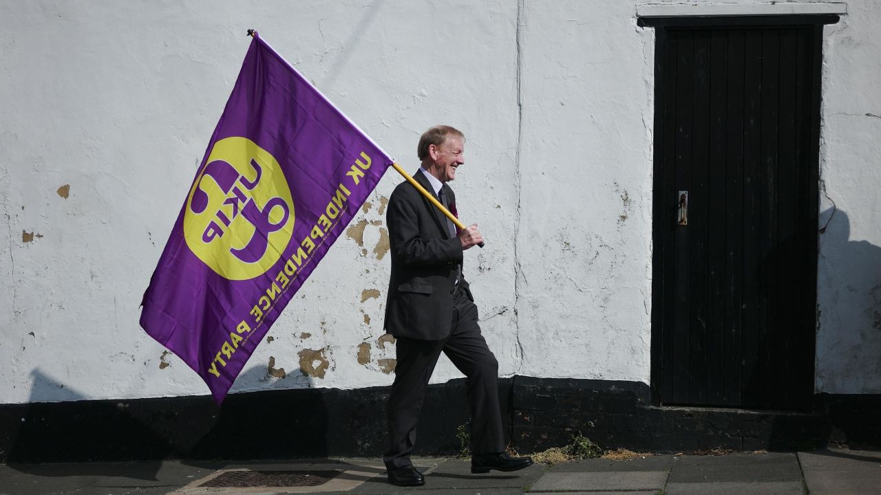 A UK Independence party supporter carries a party flag as leader Paul Nuttall visits Hartlepool on April 29, 2017 in Hartlepool, United Kingdom. 