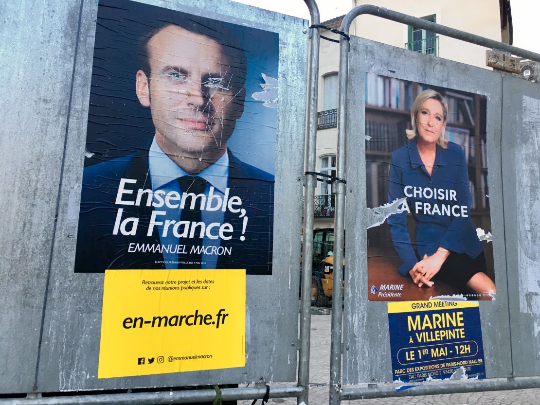 Election posters outside Beziers' town hall is seen with Macron's eyes scratched out.