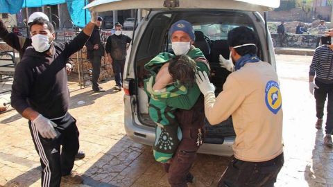 Members of Syria's White Helmets  transport victims away from the scene.