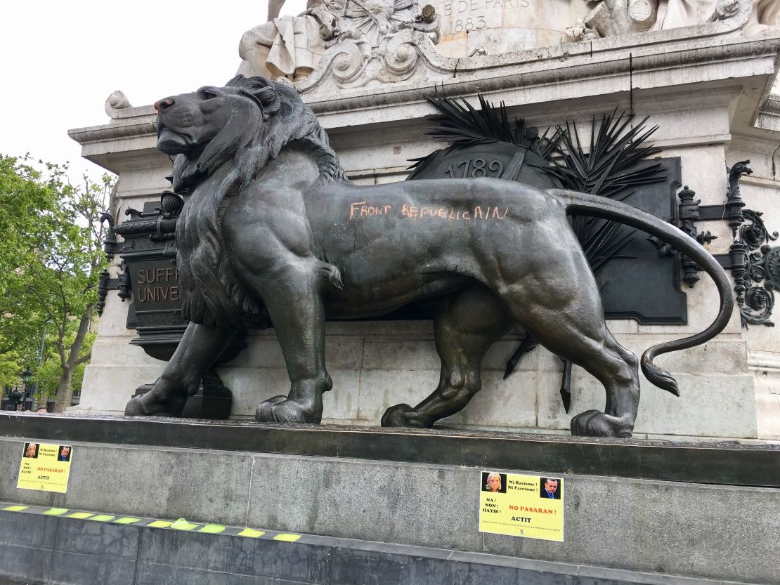 One of the lions at the base of the statue in Paris' Place de la Republique has been defaced with graffiti. 