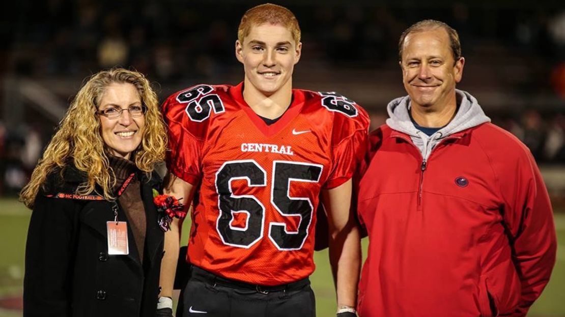 Tim Piazza, flanked by his parents, in high school.