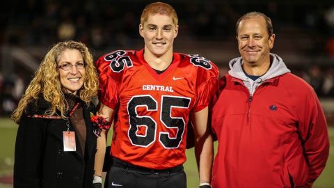 Tim Piazza, flanked by his parents, in high school.