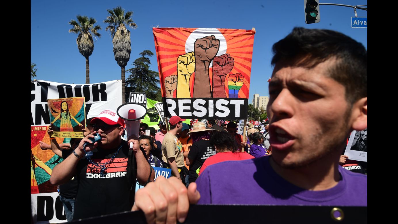 People protest Trump's immigration policies during a march in Los Angeles on Monday, May 1.