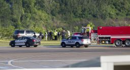 Emergency officials work near the crash site Friday at Yeager Airport.