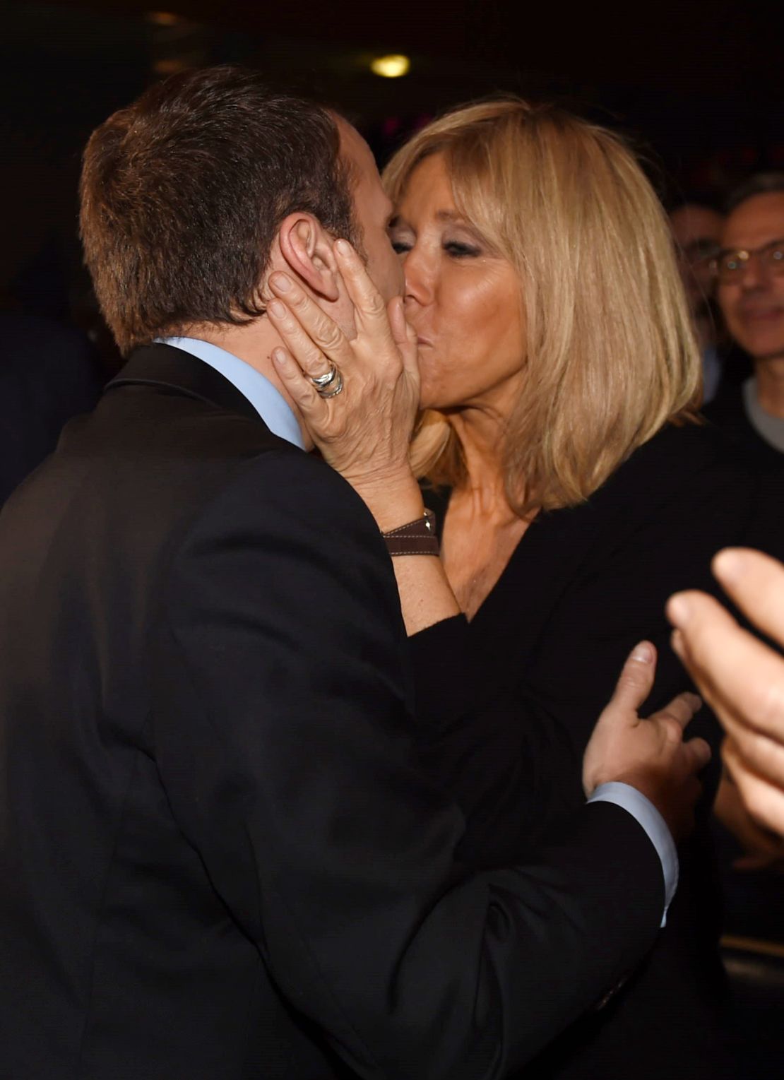 Emmanuel Macron kisses his wife as he arrives for a campaign rally on March 9.