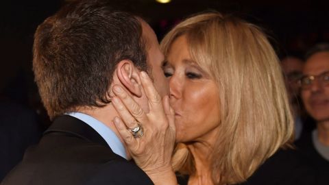 Emmanuel Macron kisses his wife as he arrives for a campaign rally on March 9.