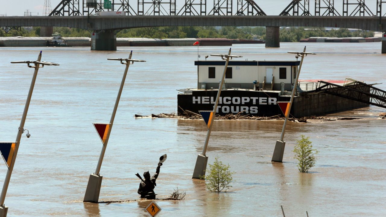 The Captains' Return statue, which honors explorers Lewis and Clark, sits partially submerged on May 5, in a flooding Mississippi River in St. Louis. The statue was just moved to higher ground to avoid floods.