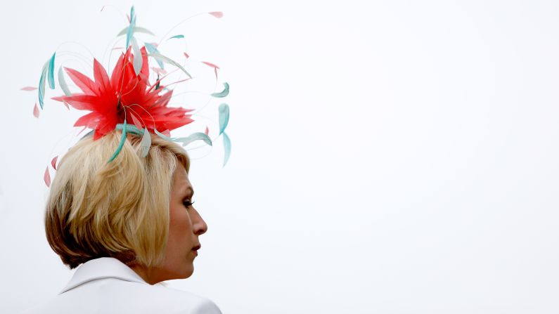A woman watches an early race before the 143rd Kentucky Derby.
