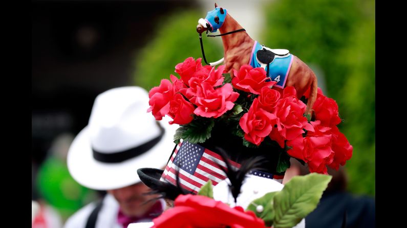 A small racehorse figure sits atop a man's hat at the 143rd Kentucky Derby at Churchill Downs on Saturday, May 6, in Louisville.