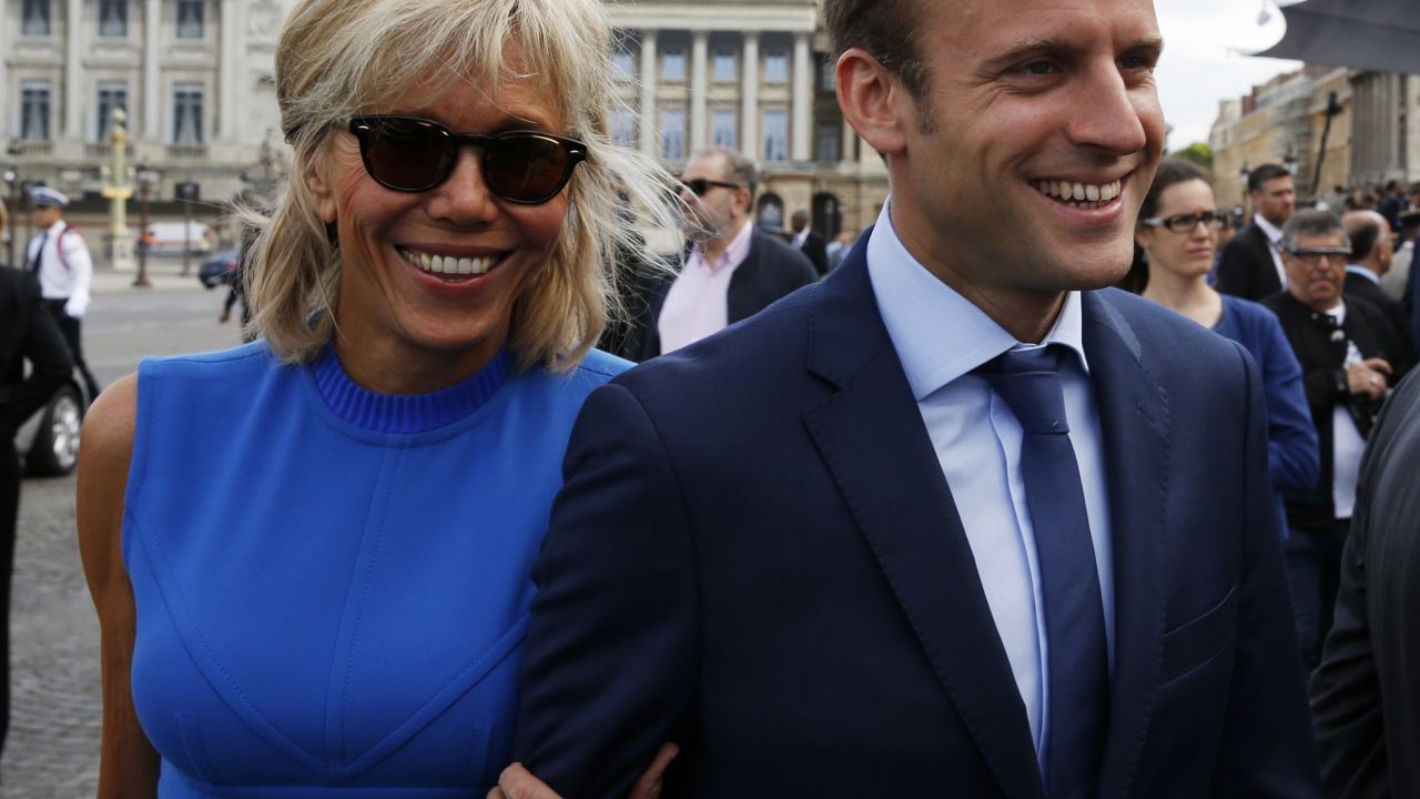 French Economy minister Emmanuel Macron (R) and his wife Brigitte Trogneux arrive to attend the annual Bastille Day military parade in Paris on July 14, 2015.  AFP PHOTO / POOL / PASCAL ROSSIGNOL 
 REUTERS/Pascal Rossignol /POOL        (Photo credit should read PASCAL ROSSIGNOL/AFP/Getty Images)