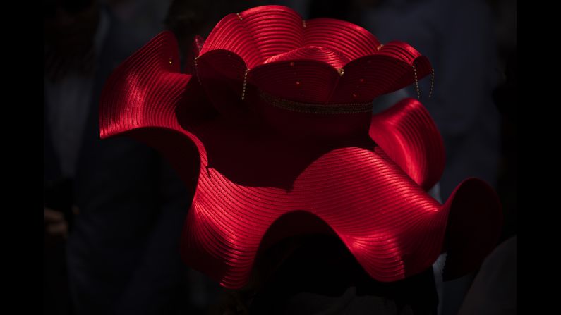 A hat is illuminated by the sun as attendees watch the red carpet arrivals.