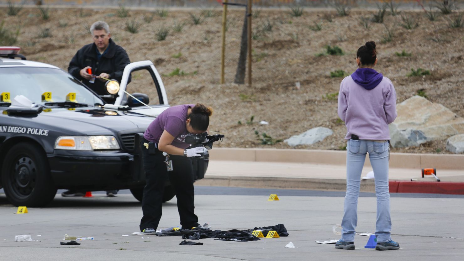 San Diego Police Department officers collect evidence at the scene of a fatal officer-involved shooting of a 15-year-old boy. 